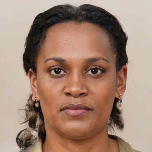 Joyful black young-adult female with medium  brown hair and brown eyes