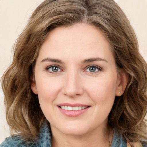 Joyful white young-adult female with medium  brown hair and blue eyes