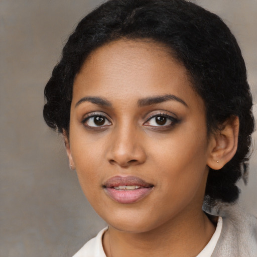 Joyful black young-adult female with medium  black hair and brown eyes
