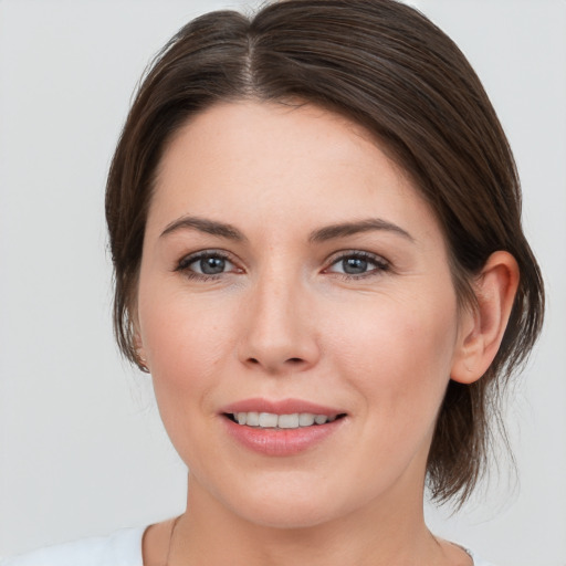 Joyful white young-adult female with medium  brown hair and brown eyes