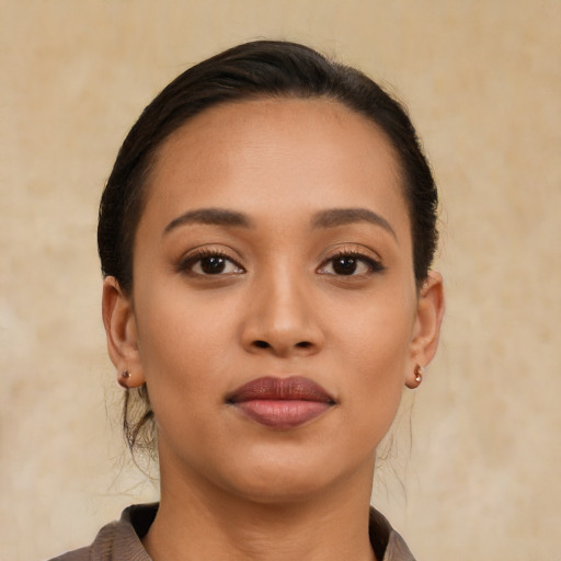 Joyful latino young-adult female with short  brown hair and brown eyes