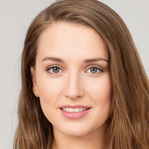 Joyful white young-adult female with long  brown hair and green eyes