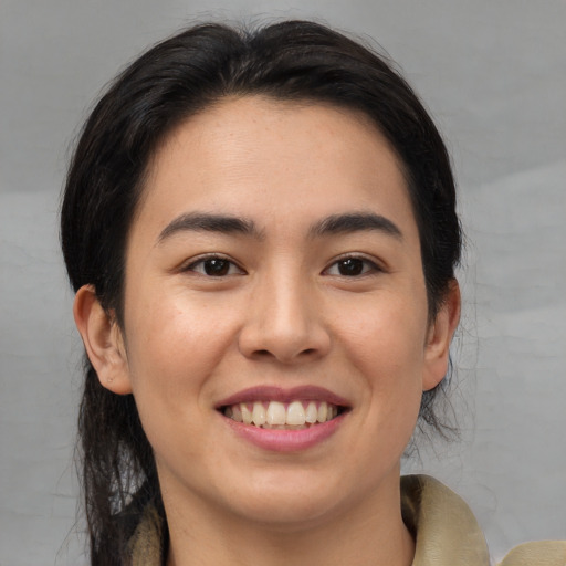 Joyful asian young-adult female with medium  brown hair and brown eyes