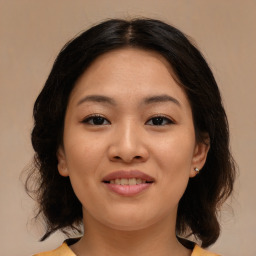 Joyful asian young-adult female with medium  brown hair and brown eyes