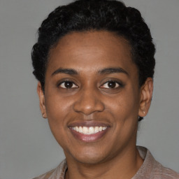 Joyful black young-adult female with short  black hair and brown eyes
