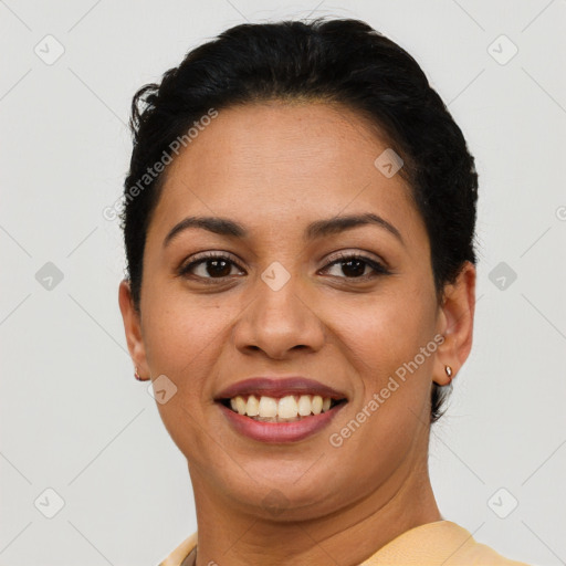 Joyful latino young-adult female with short  brown hair and brown eyes