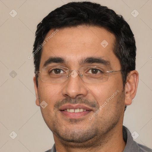 Joyful white adult male with short  black hair and brown eyes
