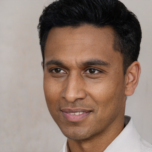 Joyful latino adult male with short  black hair and brown eyes