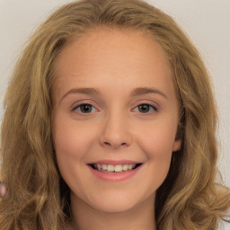 Joyful white child female with long  brown hair and brown eyes