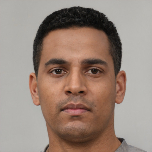 Neutral latino young-adult male with short  black hair and brown eyes