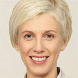 Joyful white adult female with short  blond hair and blue eyes