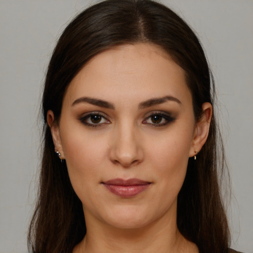 Joyful white young-adult female with long  brown hair and brown eyes