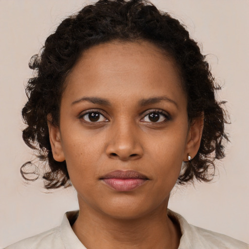 Neutral black young-adult female with medium  brown hair and brown eyes