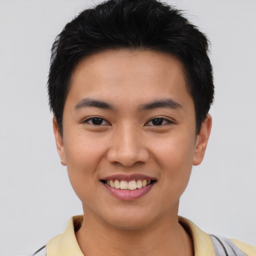 Joyful asian young-adult male with short  black hair and brown eyes