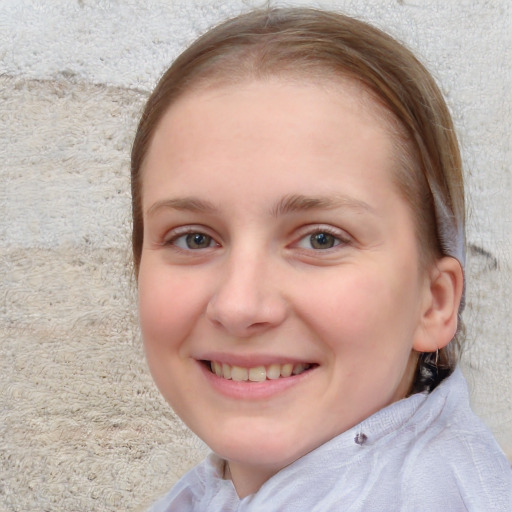 Joyful white child female with short  brown hair and blue eyes