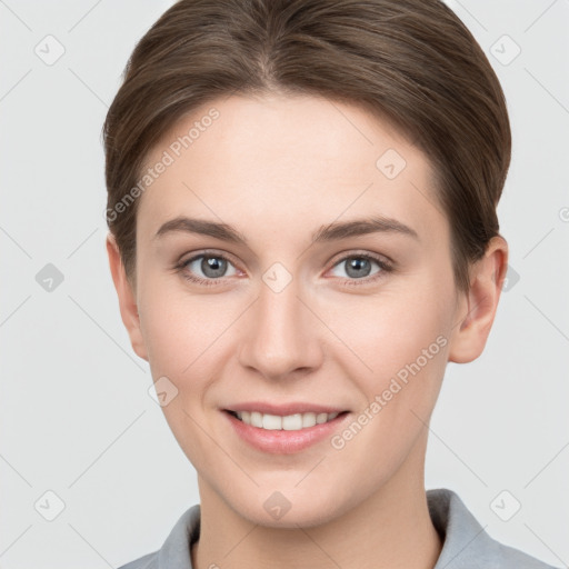 Joyful white young-adult female with short  brown hair and grey eyes