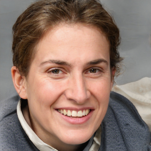 Joyful white adult female with medium  brown hair and blue eyes