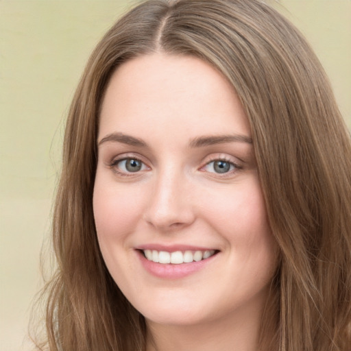 Joyful white young-adult female with long  brown hair and green eyes