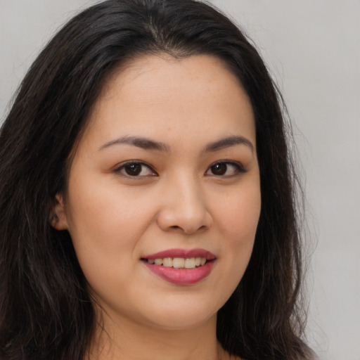 Joyful asian young-adult female with long  brown hair and brown eyes