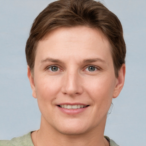 Joyful white young-adult female with short  brown hair and grey eyes