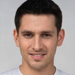 Joyful white young-adult male with short  brown hair and brown eyes