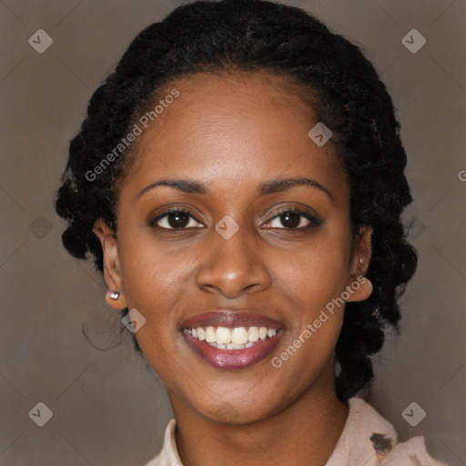 Joyful black young-adult female with long  black hair and brown eyes