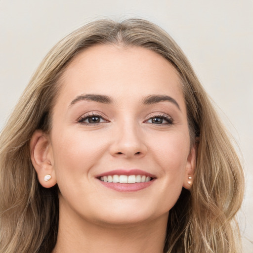 Joyful white young-adult female with long  brown hair and grey eyes