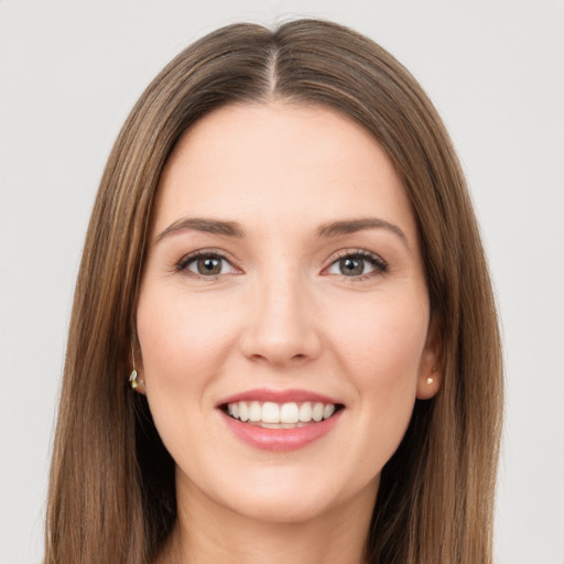 Joyful white young-adult female with long  brown hair and brown eyes