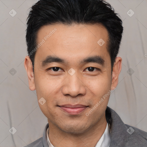 Joyful asian young-adult male with short  black hair and brown eyes