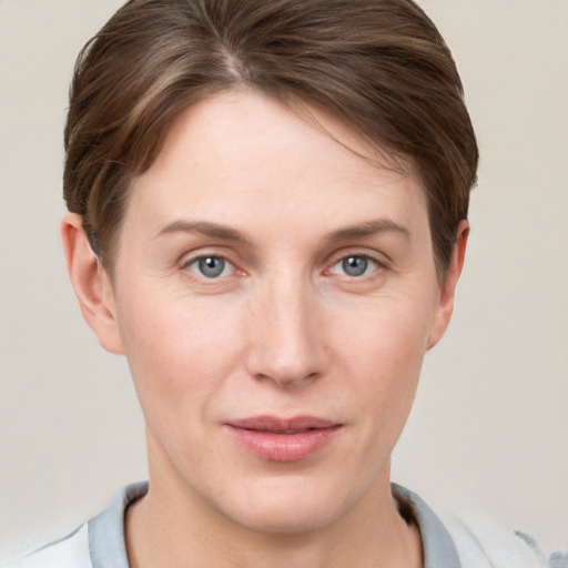 Joyful white young-adult female with short  brown hair and grey eyes