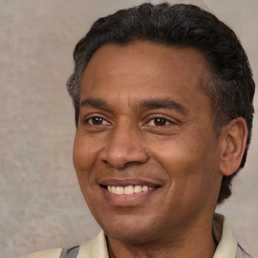 Joyful latino adult male with short  black hair and brown eyes