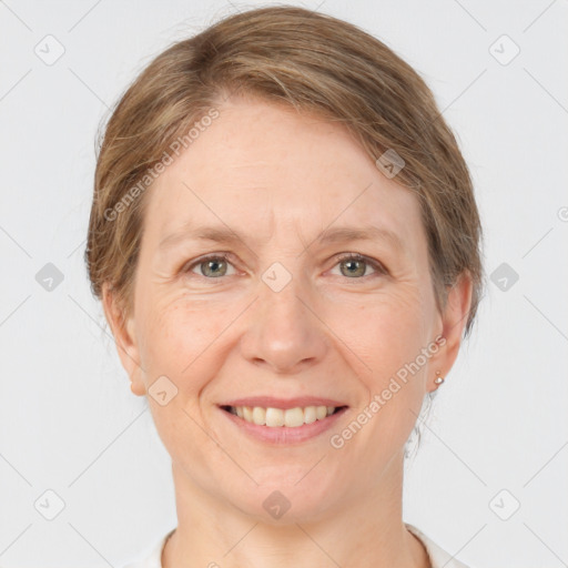 Joyful white adult female with medium  brown hair and grey eyes