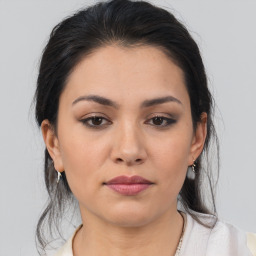 Joyful latino young-adult female with medium  brown hair and brown eyes