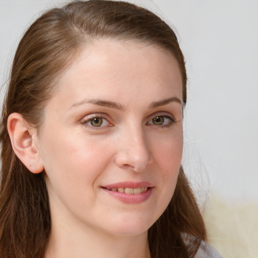 Joyful white young-adult female with long  brown hair and blue eyes