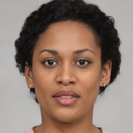 Joyful black young-adult female with short  brown hair and brown eyes