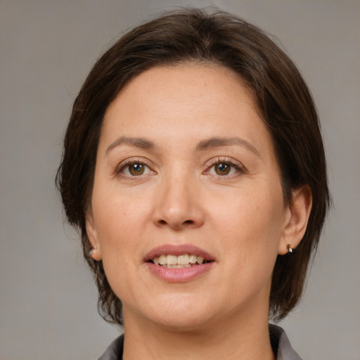 Joyful white adult female with medium  brown hair and brown eyes