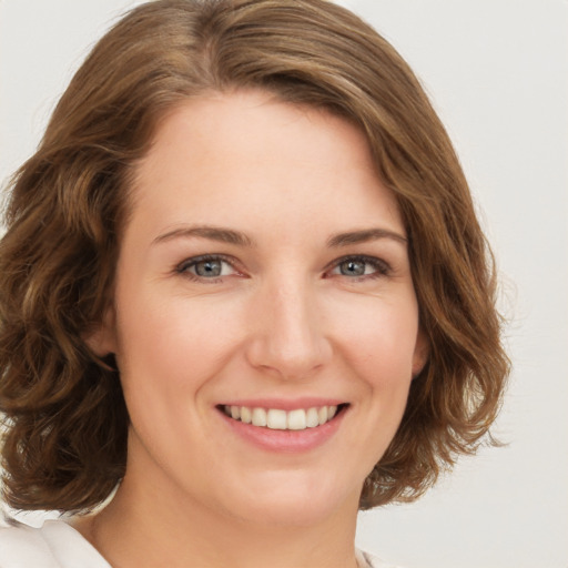 Joyful white young-adult female with medium  brown hair and green eyes