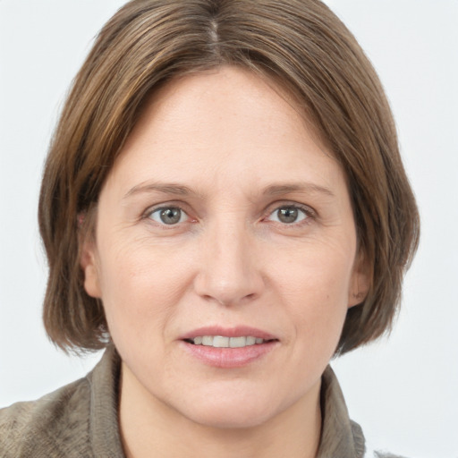 Joyful white adult female with medium  brown hair and grey eyes