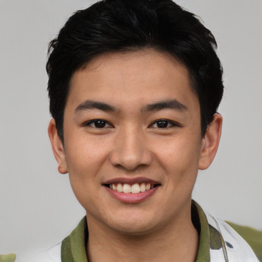 Joyful asian young-adult male with short  black hair and brown eyes