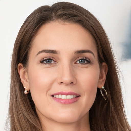 Joyful white young-adult female with long  brown hair and grey eyes