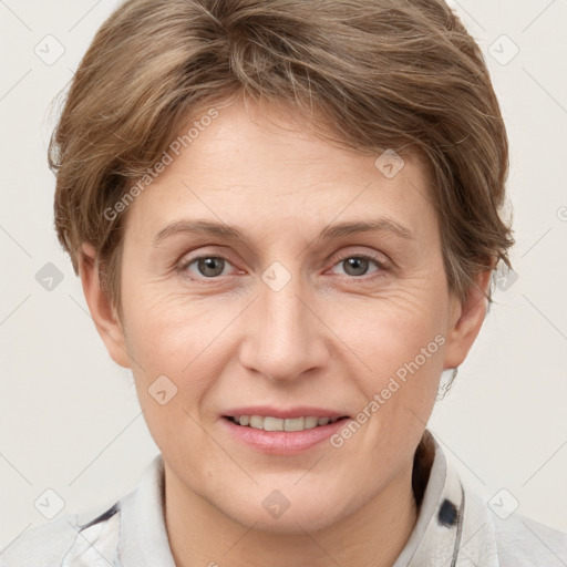 Joyful white adult female with short  brown hair and grey eyes