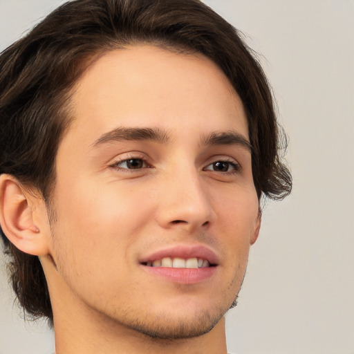 Joyful white young-adult male with medium  brown hair and brown eyes