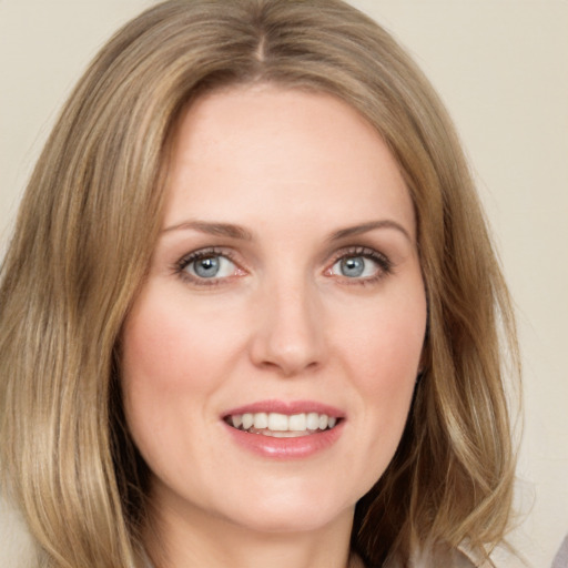 Joyful white young-adult female with long  brown hair and green eyes