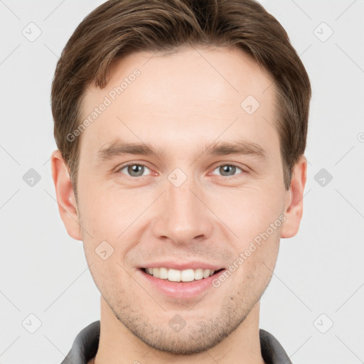 Joyful white young-adult male with short  brown hair and grey eyes