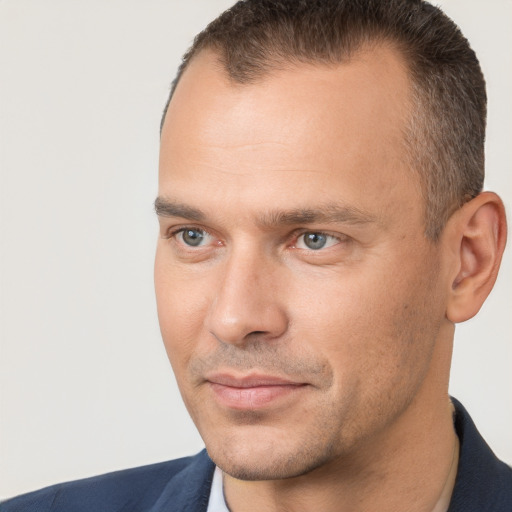 Joyful white adult male with short  brown hair and brown eyes