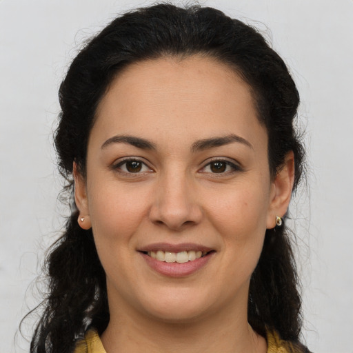 Joyful latino young-adult female with long  brown hair and brown eyes