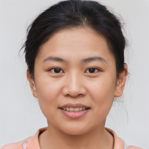 Joyful asian young-adult female with short  brown hair and brown eyes