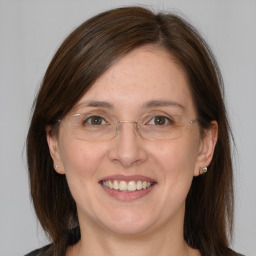 Joyful white adult female with medium  brown hair and brown eyes