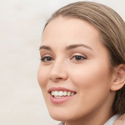 Joyful white young-adult female with long  brown hair and blue eyes