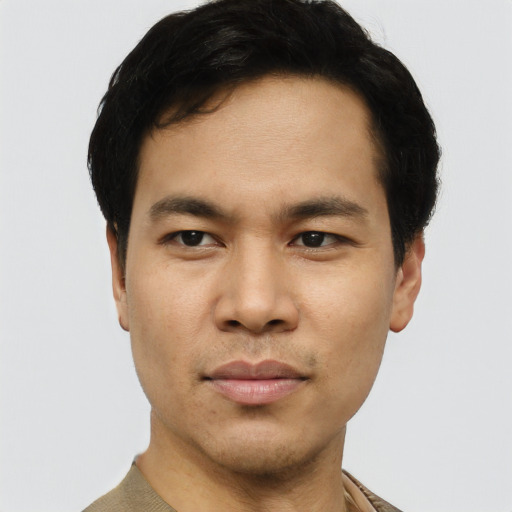 Joyful asian young-adult male with short  black hair and brown eyes
